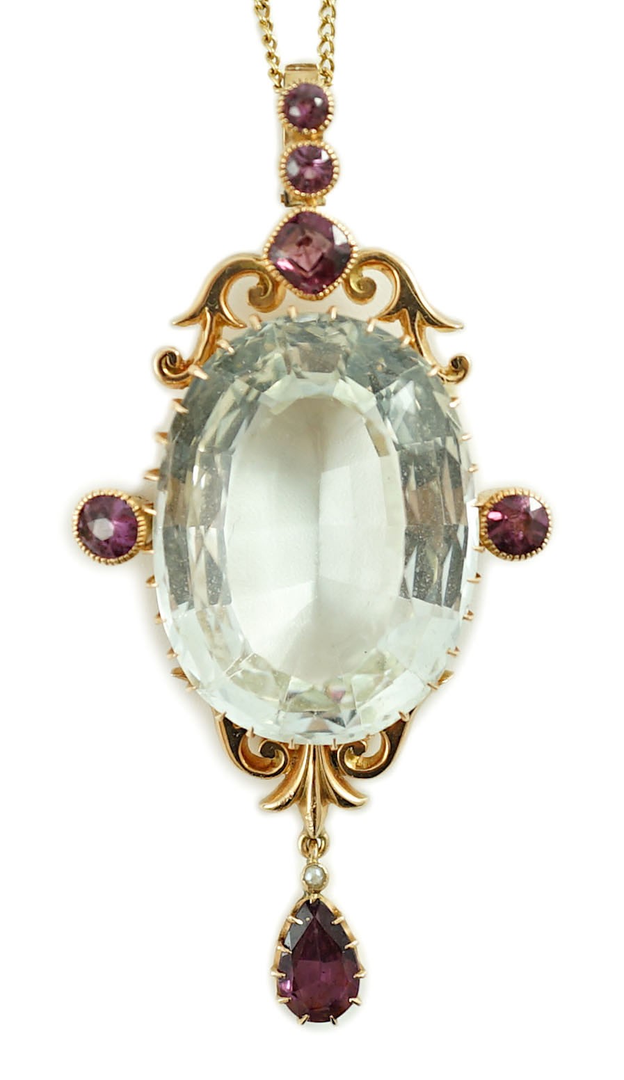 An early 20th century gold, aquamarine and garnet cluster set drop pendant, on a gold fine link chain